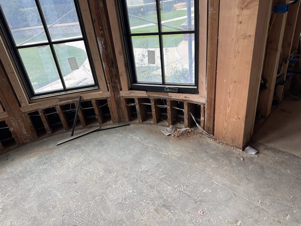 Residential remodel with walls opened to expose framing, wiring, and existing conditions